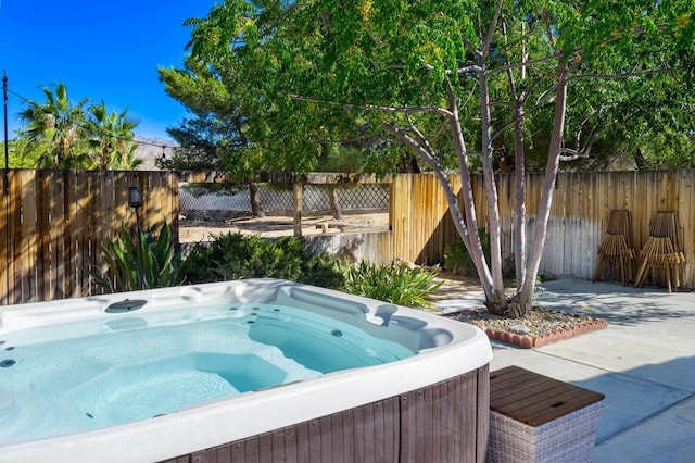 view of swimming pool with a hot tub and a patio