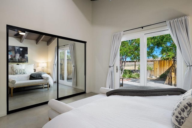 bedroom with access to outside and vaulted ceiling with beams