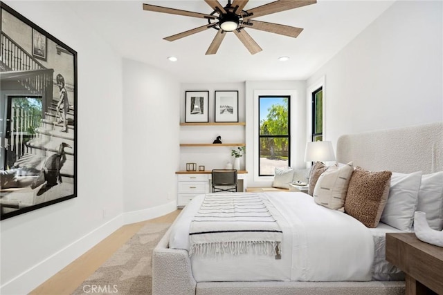 bedroom with light hardwood / wood-style flooring and ceiling fan