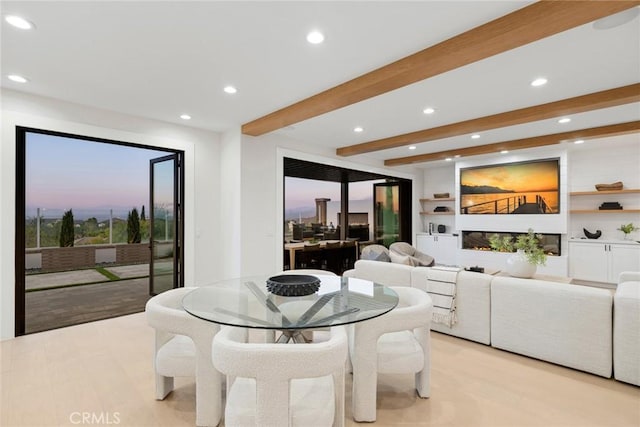 dining area with beamed ceiling, light hardwood / wood-style floors, and built in features