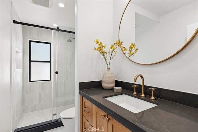 bathroom featuring vanity, toilet, and walk in shower