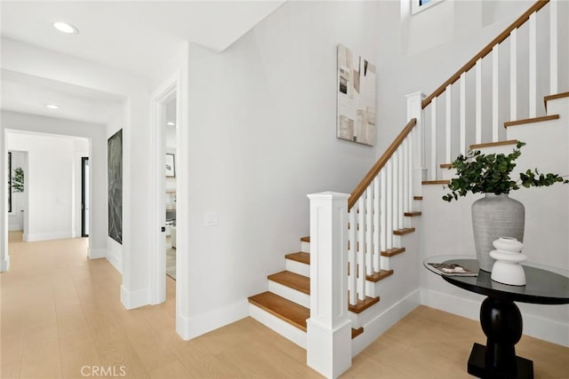 stairs with hardwood / wood-style floors