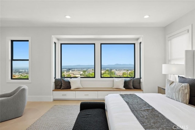 bedroom featuring a mountain view and light carpet