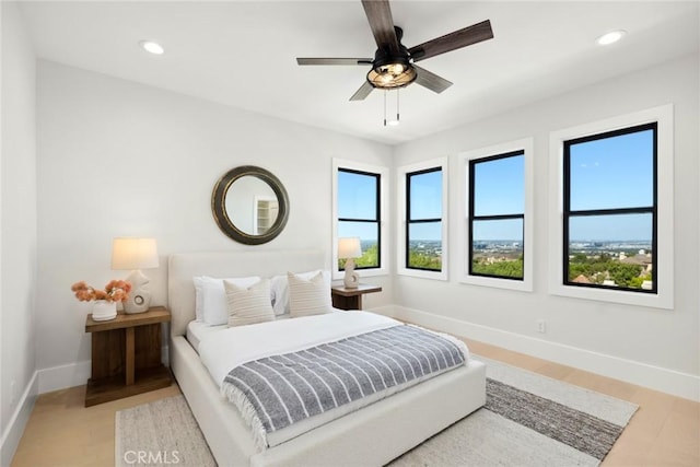 bedroom featuring light hardwood / wood-style floors and ceiling fan