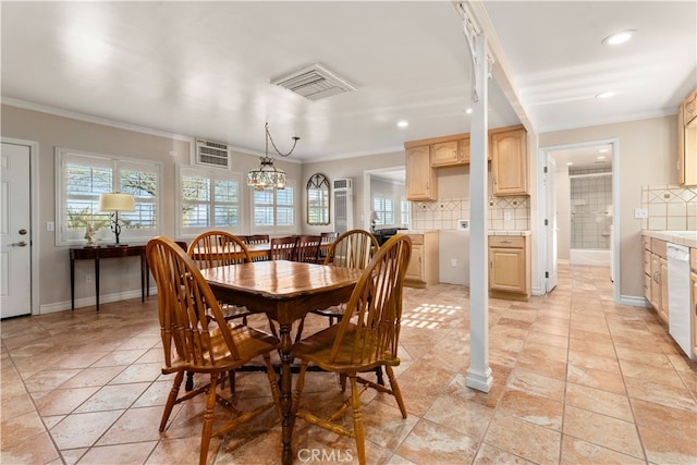 tiled dining space featuring a notable chandelier and crown molding