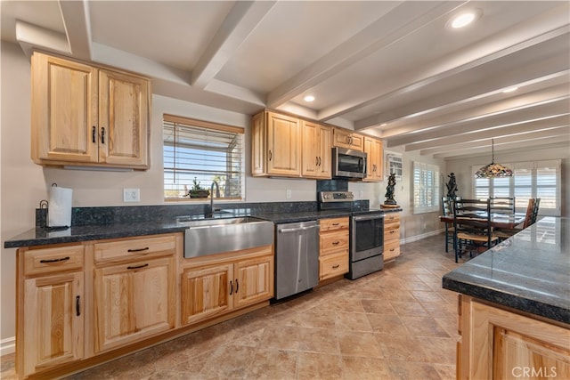 kitchen featuring plenty of natural light, beamed ceiling, pendant lighting, sink, and appliances with stainless steel finishes