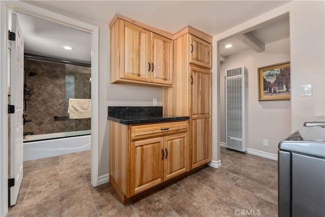 kitchen with light brown cabinetry and washing machine and dryer