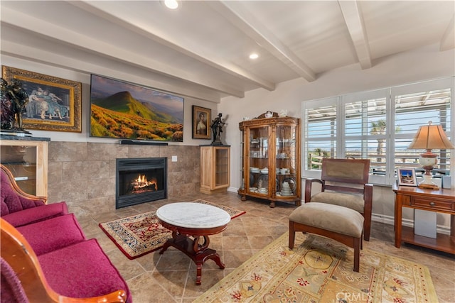 living room with beamed ceiling, tile walls, and a tile fireplace