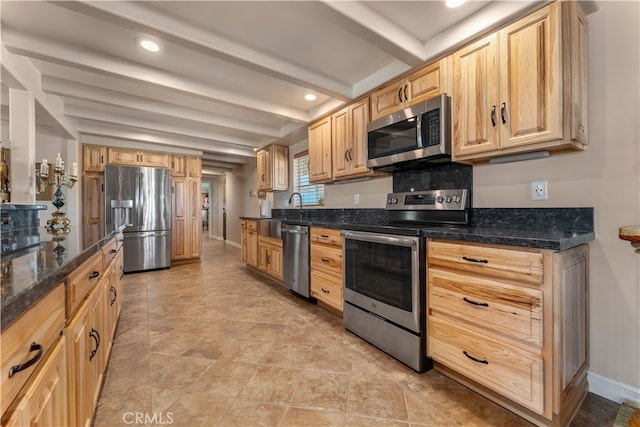 kitchen with light brown cabinets, sink, beam ceiling, stainless steel appliances, and dark stone counters