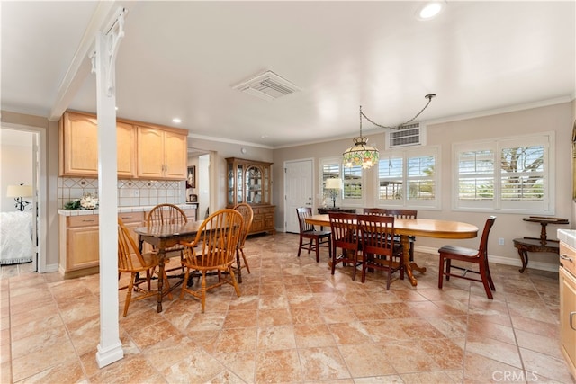 dining area with a healthy amount of sunlight and crown molding