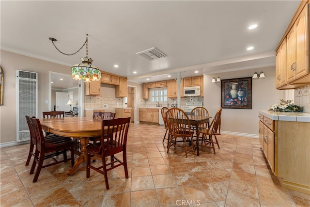 dining area featuring ornamental molding