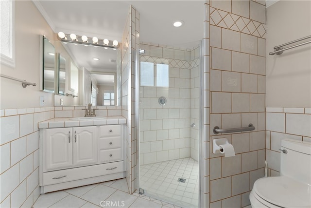 bathroom featuring vanity, tile walls, and toilet