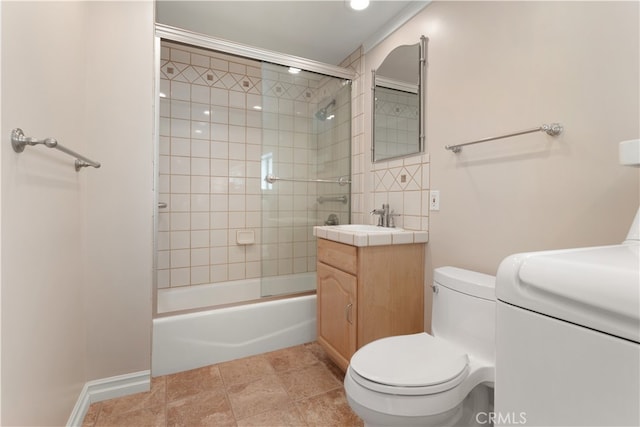 full bathroom featuring vanity, tiled shower / bath, washer and clothes dryer, tile patterned flooring, and toilet