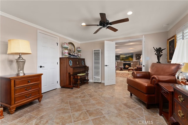 living room with ornamental molding and ceiling fan