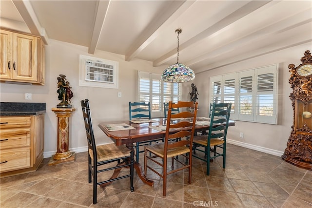 dining area featuring beam ceiling