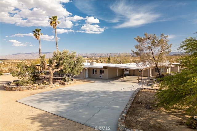 view of front of property featuring a mountain view and a patio