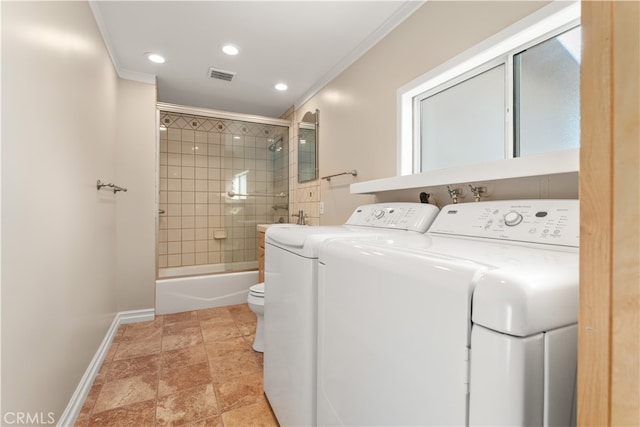 laundry room featuring crown molding and separate washer and dryer