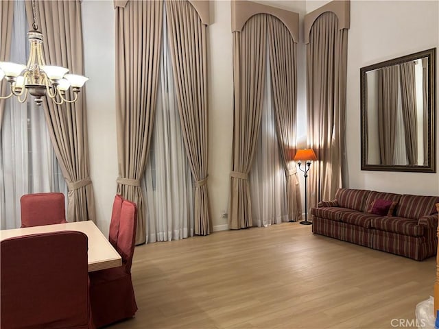 living room featuring a notable chandelier and wood finished floors