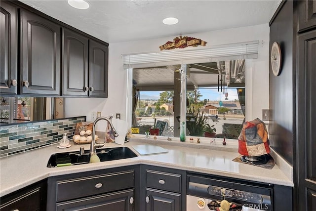 kitchen with dishwashing machine, sink, and tasteful backsplash