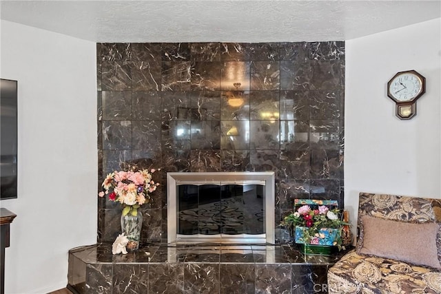 details with a fireplace and a textured ceiling