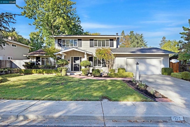 view of property with a front lawn and a garage