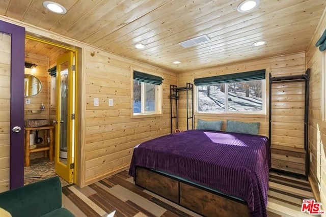 bedroom featuring wood walls, wood-type flooring, and wooden ceiling