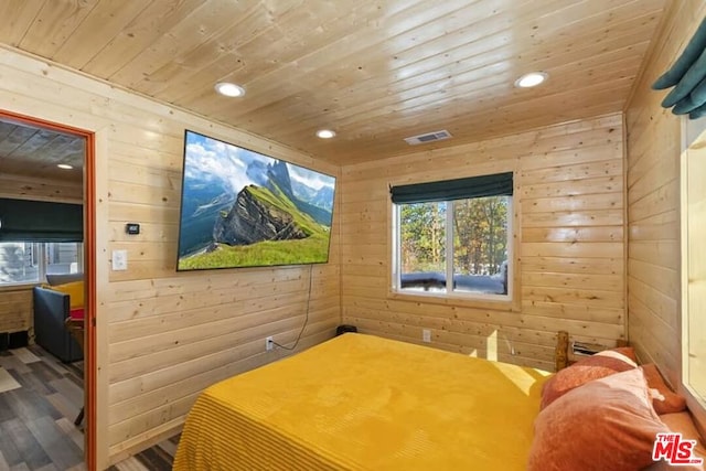 bedroom with wooden ceiling, hardwood / wood-style flooring, and wooden walls