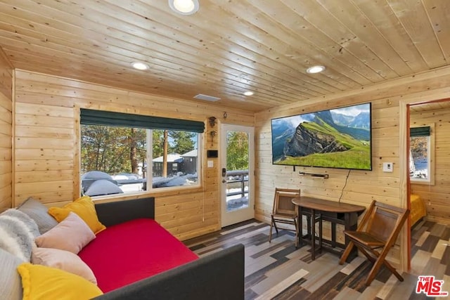 living area featuring wooden walls, wood-type flooring, and wooden ceiling