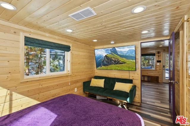 bedroom featuring wood-type flooring, wood ceiling, and wooden walls