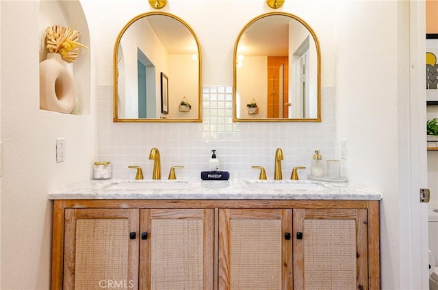 bathroom with decorative backsplash and vanity