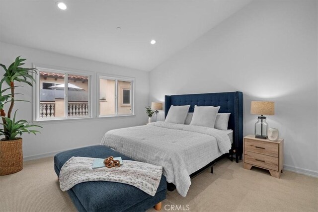 carpeted bedroom featuring vaulted ceiling