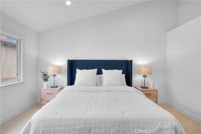 carpeted bedroom featuring vaulted ceiling