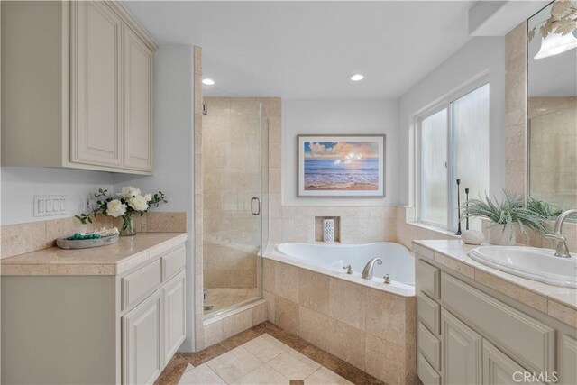 bathroom with vanity, shower with separate bathtub, and tile patterned floors