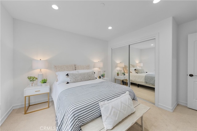 bedroom featuring a closet and light carpet