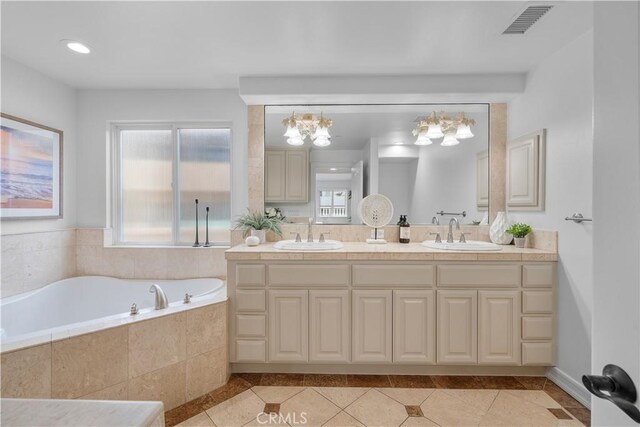 bathroom with vanity and a relaxing tiled tub