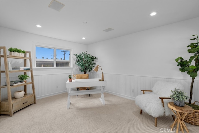 office space featuring wooden walls and light colored carpet