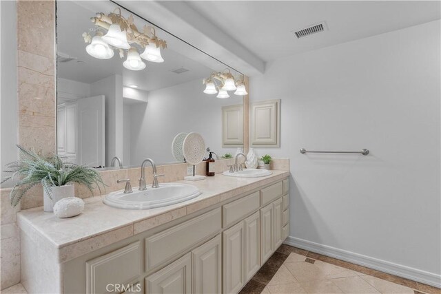 bathroom with vanity, a notable chandelier, and tile patterned flooring