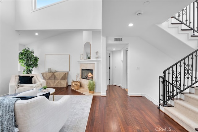 living room featuring lofted ceiling and dark hardwood / wood-style floors