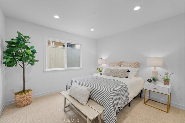 bedroom featuring light colored carpet