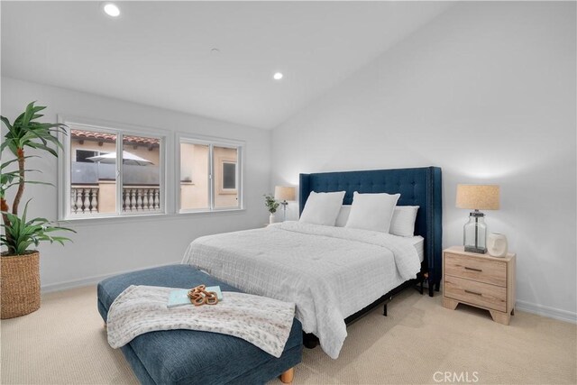 bedroom with carpet flooring and lofted ceiling