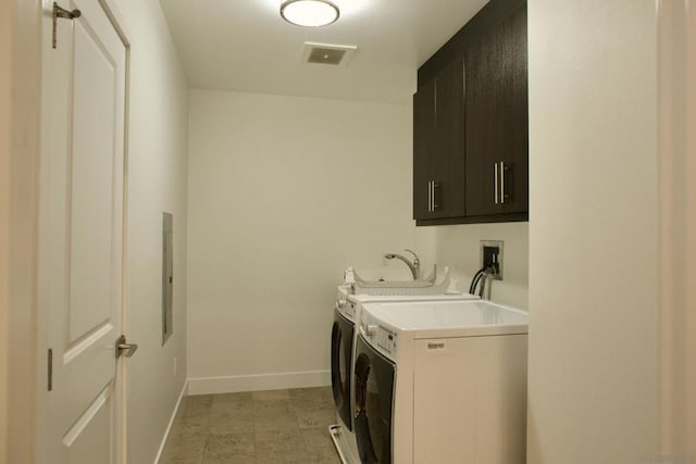 laundry area featuring cabinets and independent washer and dryer