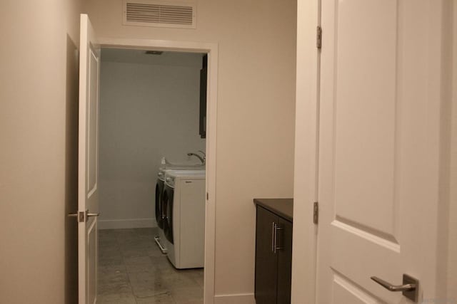 clothes washing area featuring separate washer and dryer