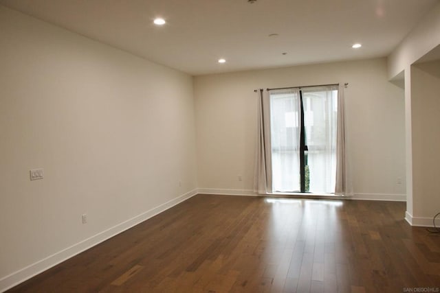 unfurnished room with dark hardwood / wood-style floors