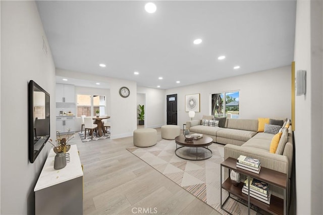 living room with a healthy amount of sunlight and light wood-type flooring