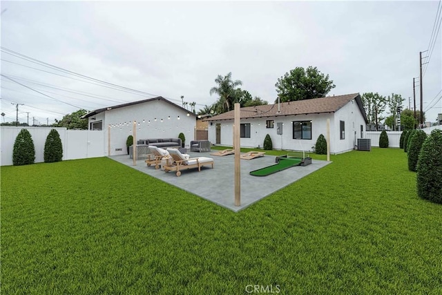 back of house featuring a patio, an outdoor hangout area, central AC, and a lawn