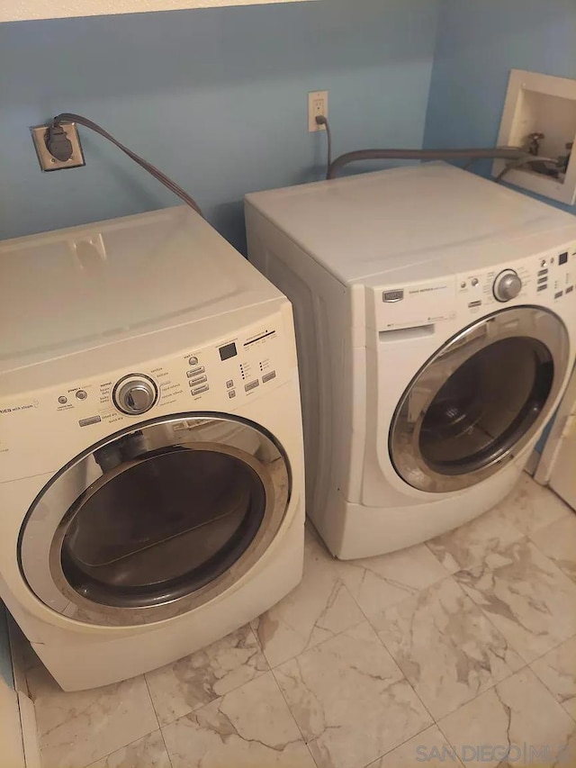 clothes washing area featuring washing machine and clothes dryer