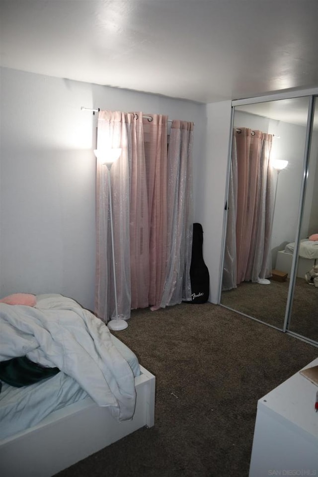 carpeted bedroom with a closet