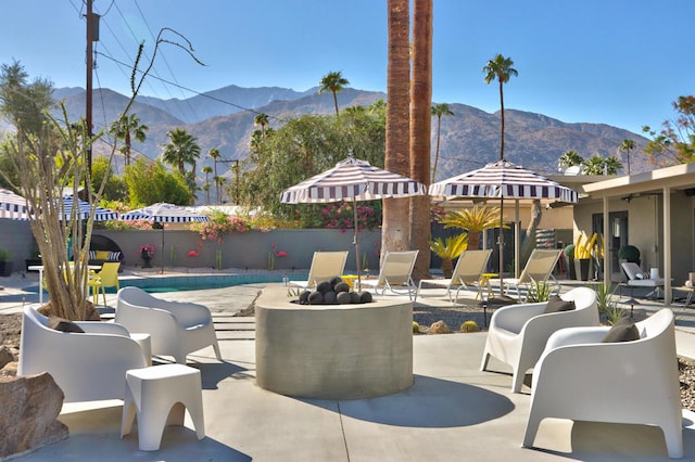 view of patio / terrace with a mountain view and a fenced in pool