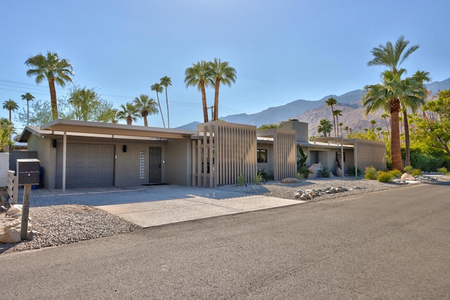 view of front of house featuring a mountain view and a garage