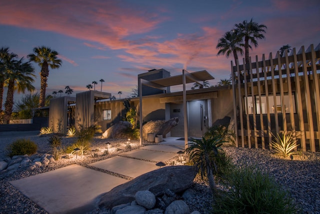 view of back house at dusk